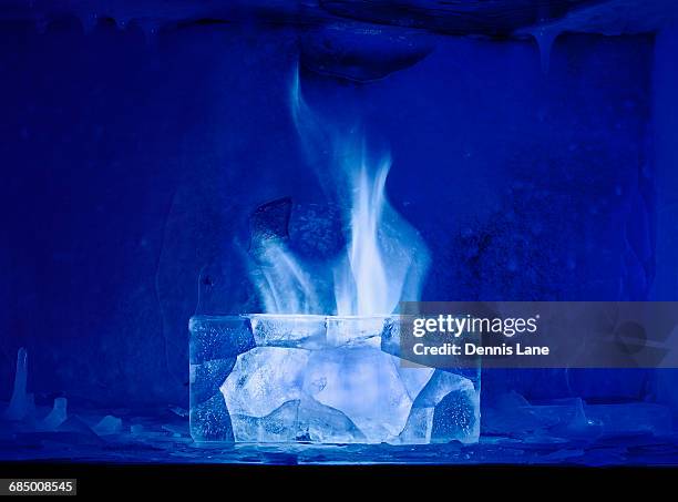white flame burning in blue ice - freeze motion stock-fotos und bilder