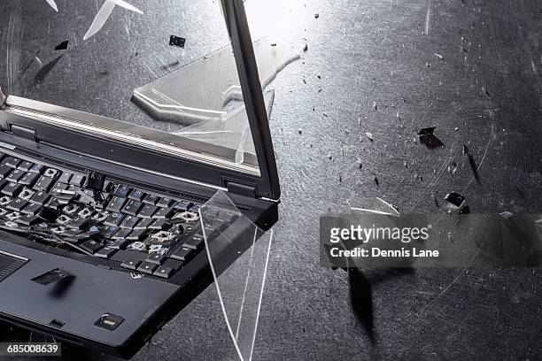 shards from shattering laptop - broken laptop stockfoto's en -beelden