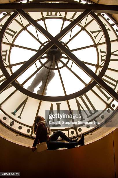 girl sitting in clock window - clock tower stock pictures, royalty-free photos & images