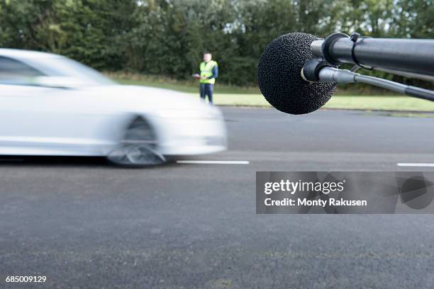 engineer measuring vehicle sound level at test track - test track stock pictures, royalty-free photos & images