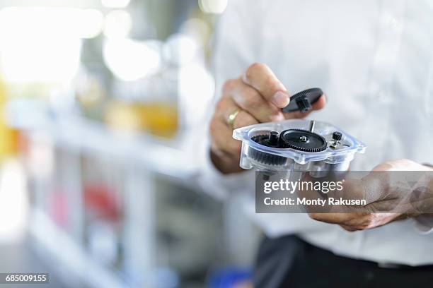 engineer holding 3d printed parts in factory, close up - 3d printen factory stockfoto's en -beelden