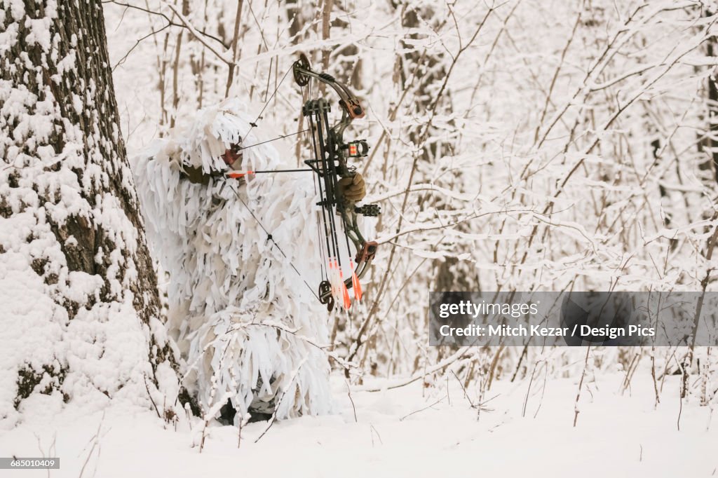 Bowhunter In Snow Ghillie Suit