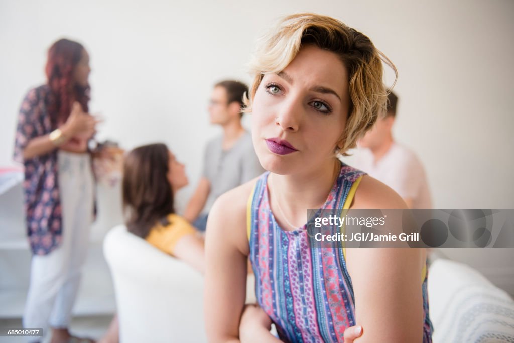 Portrait of woman sulking at party