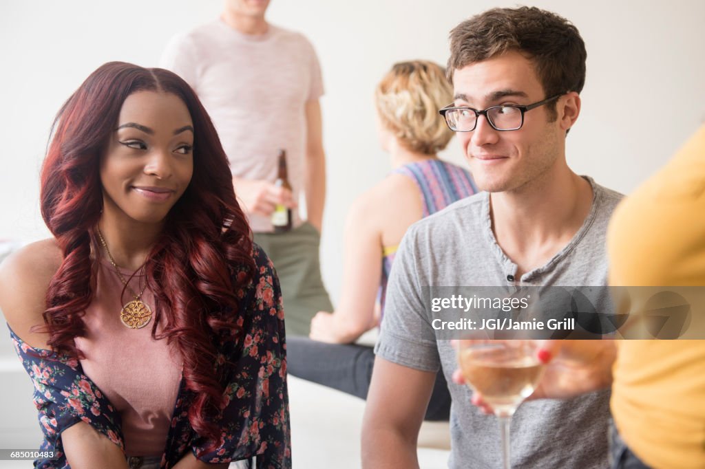 Curious couple flirting at party