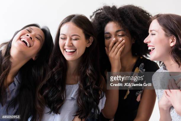 women laughing - four in a row stock pictures, royalty-free photos & images