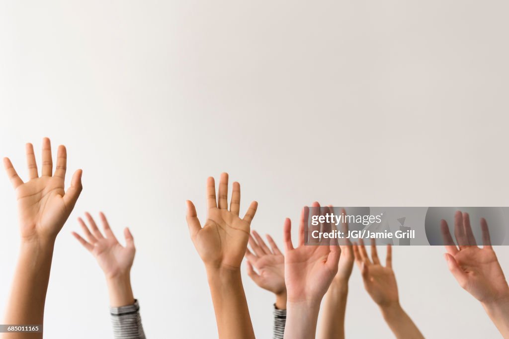 Raised hands of women