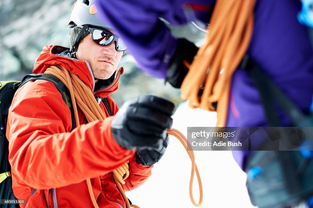 Mountaineers preparing climbing equipment