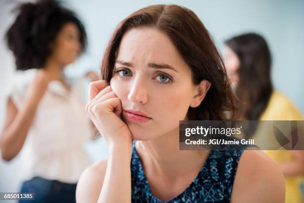 portrait of unhappy woman - fish out of water photos et images de collection