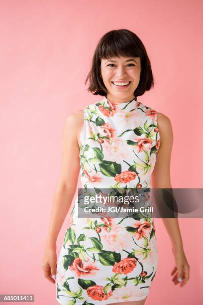 smiling hispanic woman wearing floral dress - flower dress stock pictures, royalty-free photos & images