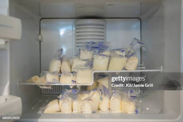 bags of frozen breast milk in freezer - muttermilch stock-fotos und bilder