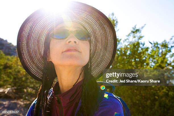 back lit japanese woman in sunny forest - a woman wear hat and sunglasses stock pictures, royalty-free photos & images