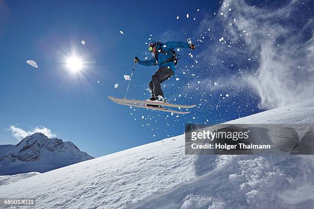 male freestyle skier jumping mid air from mountainside, zugspitze, bayern, germany - zugspitze stock pictures, royalty-free photos & images