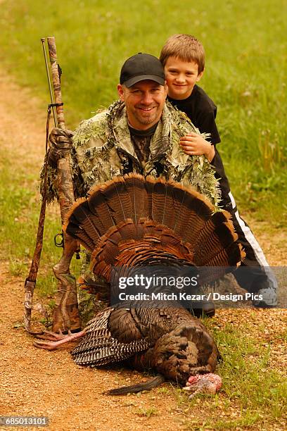 muzzleloader turkey hunter and son with turkey - turkey hunting fotografías e imágenes de stock