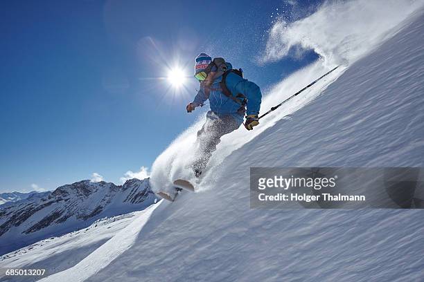 male freestyle skier skiing down mountainside, zugspitze, bayern, germany - alpen bayern fotografías e imágenes de stock