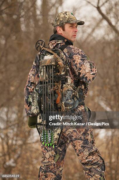 hunter wearing backpack in winter - bow hunting stock pictures, royalty-free photos & images