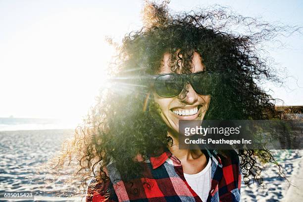 Portrait of smiling Hispanic woman at beach