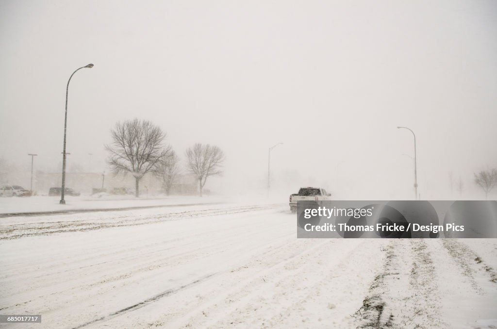 A truck driving through a blizzard