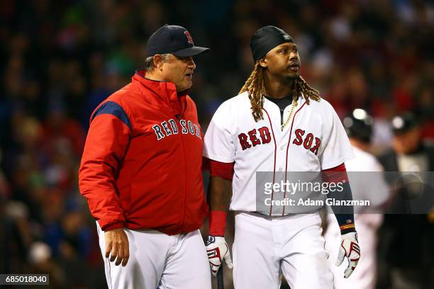 Manager John Farrell talks to Hanley Ramirez of the Boston Red Sox after he struck out in the sixth inning of a game against the Chicago Cubs at...
