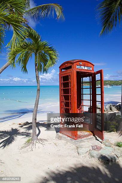 beach and red telephone box, dickenson bay, st. georges, antigua, leeward islands, west indies, caribbean, central america - antigua leeward islands stockfoto's en -beelden