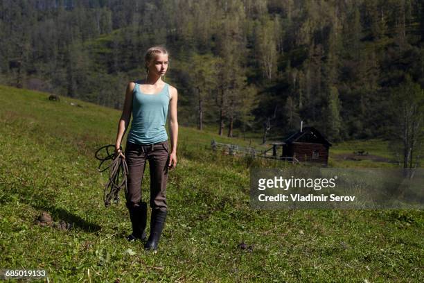 caucasian girl holding rope on hill - teen boots russian stock pictures, royalty-free photos & images
