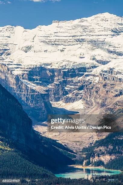 distant lake louise chateau in banff national park, victoria glacier - chateau lake louise stockfoto's en -beelden