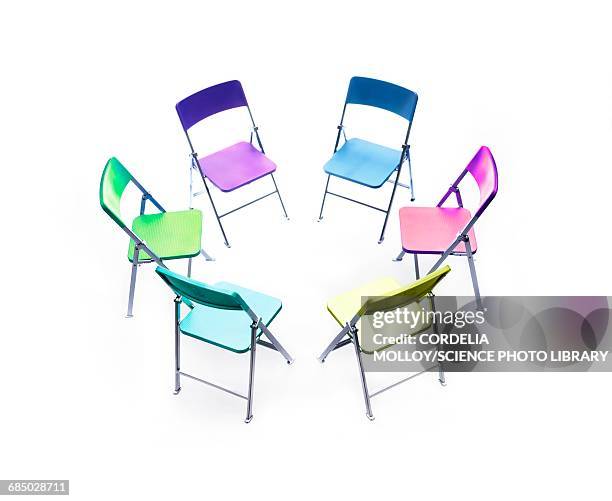 circle of chairs of different colours - business relationship stock illustrations