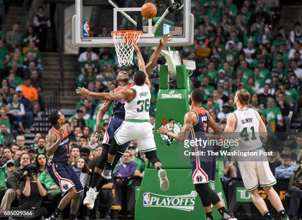 Washington Wizards center Ian Mahinmi contests a shot by Boston Celtics guard Marcus Smart during game seven of the Eastern Conference semifinals in...