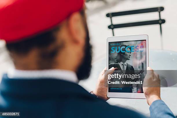 indian businessman sitting in manhattan, using digital tablet - manhattan magazine stock pictures, royalty-free photos & images