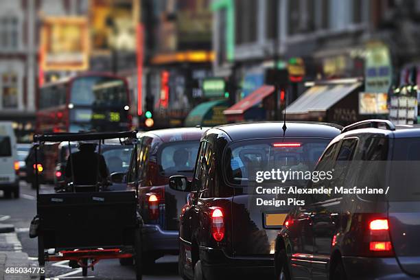 taxis and traffic on shaftsbury avenue - pedicab stock pictures, royalty-free photos & images