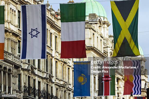 flags hanging in regent street - jamaica flag stock pictures, royalty-free photos & images