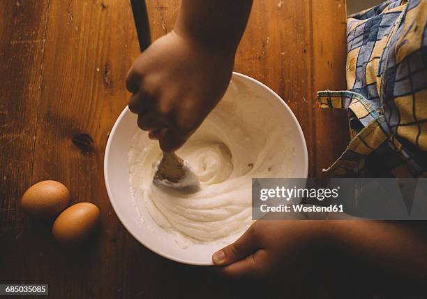 girl stirring batter for cake - stirring stock pictures, royalty-free photos & images