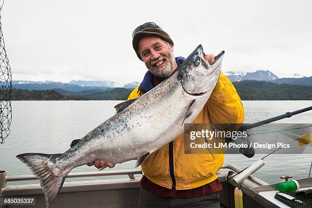 success catching king salmon (chinook salmon) (oncorhynchus tshawytscha) near homer, alaska in kachemak bay - homer alaska stock pictures, royalty-free photos & images