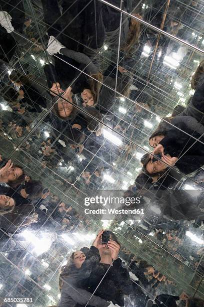 couple taking selfies in a house of mirrors - mirror reflection stock pictures, royalty-free photos & images