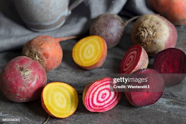 whole and sliced red and yellow beetroots - beet ストックフォトと画像