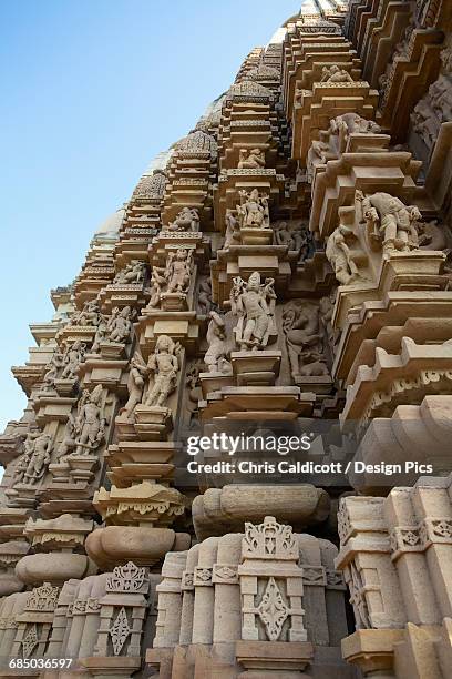 detail of stone carvings of chandala temple at khajuraho - khajuraho statues stock pictures, royalty-free photos & images