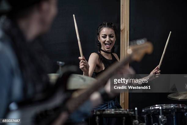 Female rock drummer at recording studio