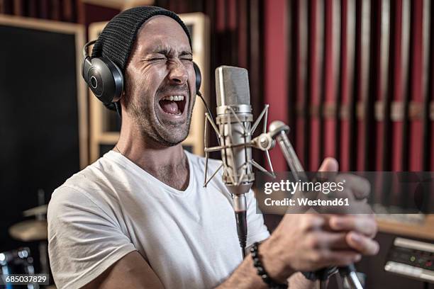 singer at recording studio - microphone mouth stock-fotos und bilder