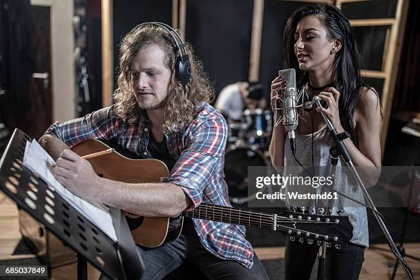 singer and guitarist in recording studio - rehearsal studio stock pictures, royalty-free photos & images