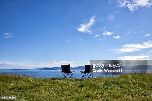 iceland, two camping chairs on a meadow - camping chair stock pictures, royalty-free photos & images