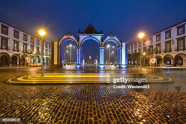 portugal, azores, sao miguel, ponta delgada city gate at night - ponta delgada stock pictures, royalty-free photos & images