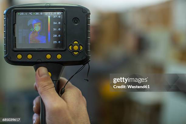 electrician holding thermal imaging camera - thermal image fotografías e imágenes de stock