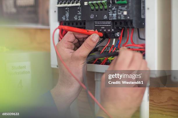 electrician working on electrical panel - voltmeter stock pictures, royalty-free photos & images