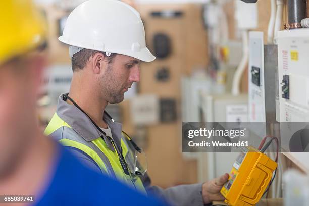 electrician working with voltmeter - voltmeter stock pictures, royalty-free photos & images