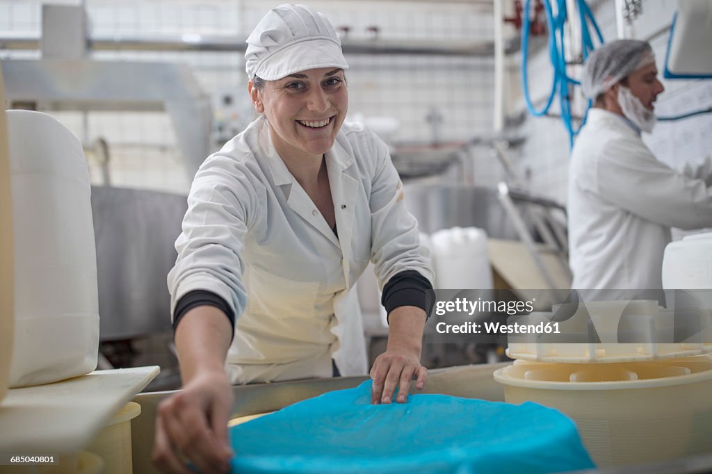 Cheese factory worker at work, portrait