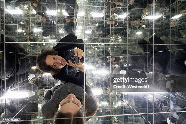 couple taking selfies in a house of mirrors - unendlich stock-fotos und bilder