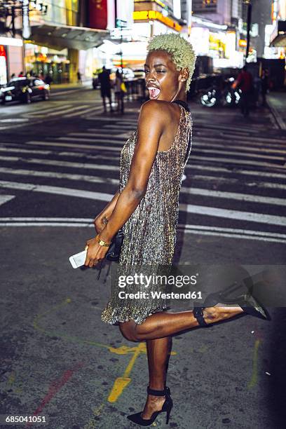 usa, new york city, extravagant young woman on times square at night - destination fashion 2016 stock pictures, royalty-free photos & images