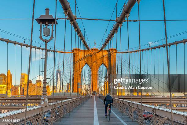 usa, new york, manhattan, brooklyn bridge over east river, lower manhattan skyline, including freedom tower of world trade center - alan copson stock pictures, royalty-free photos & images