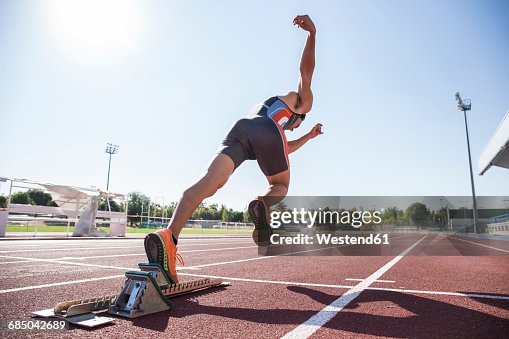 Runner on tartan track starting Runner on tartan track starting