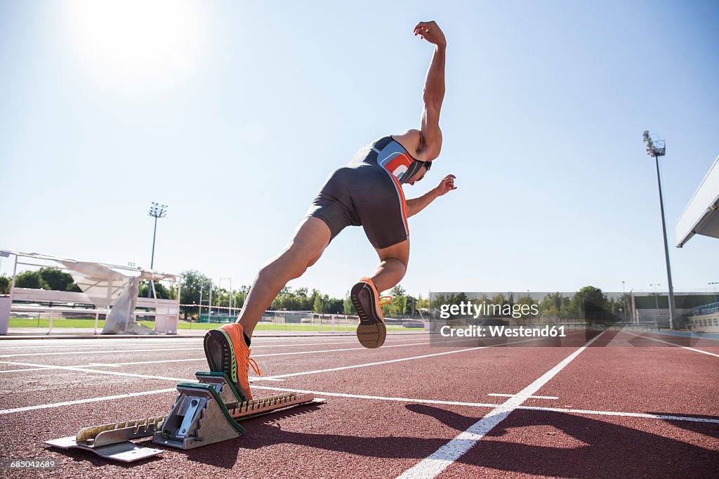 Runner on tartan track starting