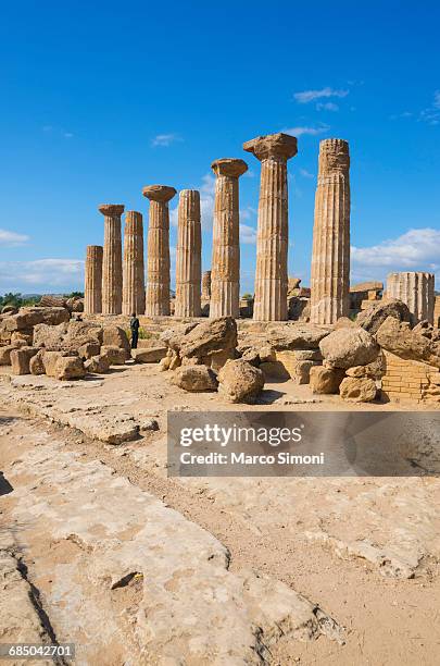 remains of temple of heracles, valley of the temples, agrigento, sicily, italy - ancient greece photos stock-fotos und bilder